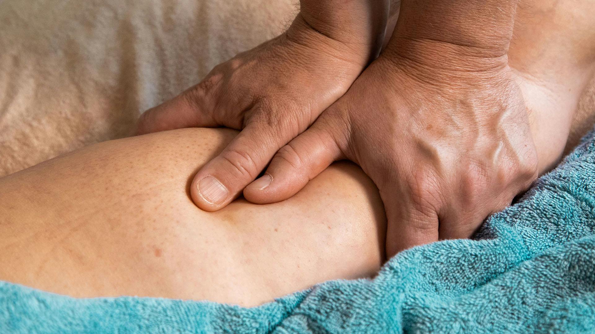 A person receiving a deep tissue massage